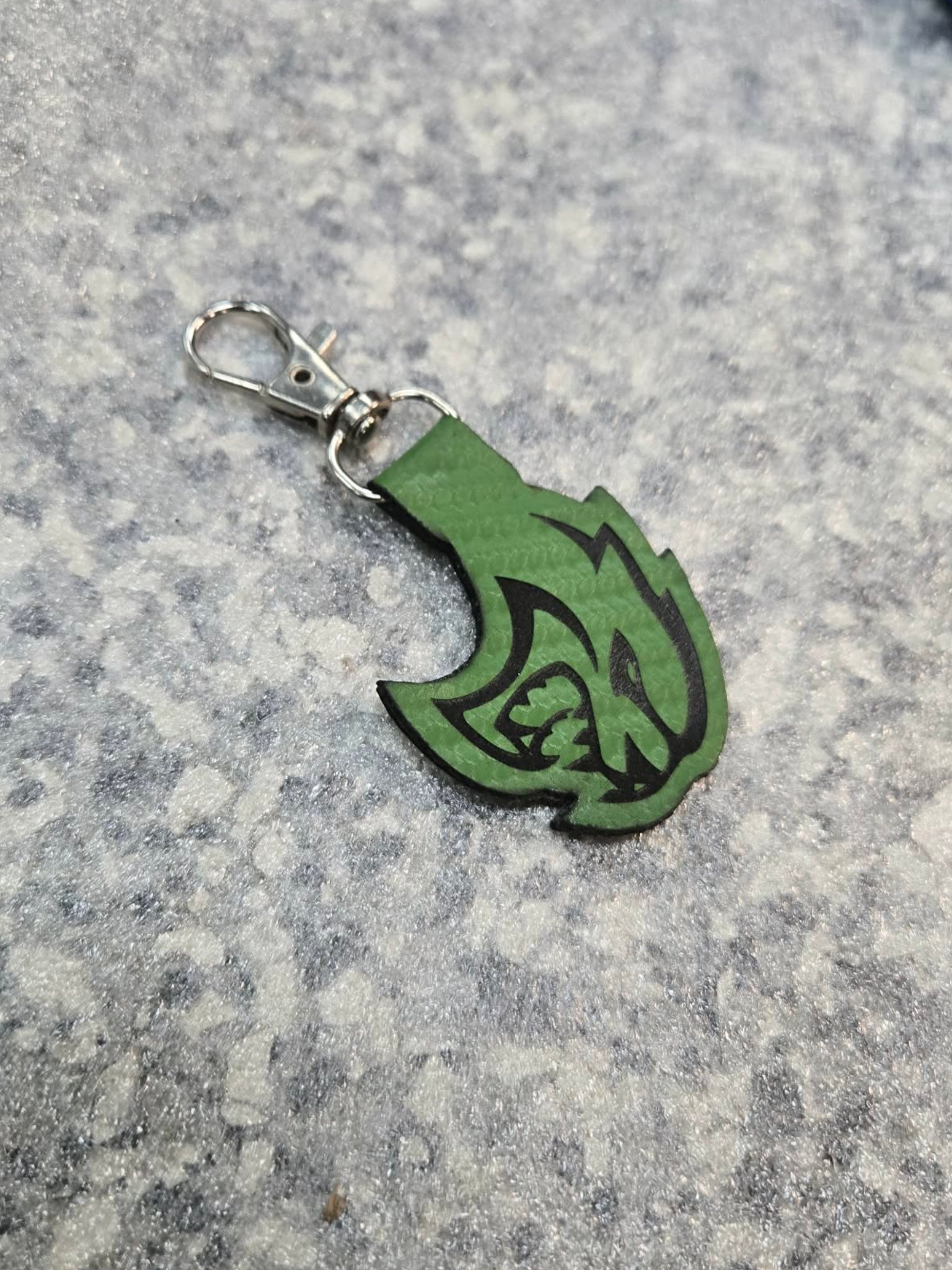 Green carbon‑fiber style keychain with engraved hellcat‑inspired design, lightweight custom automotive accessory.