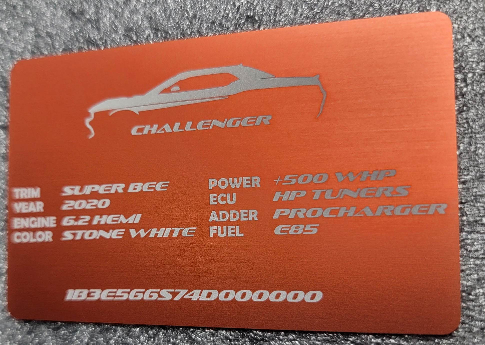 Orange anodized aluminum Dodge Challenger build plate with engraved specs