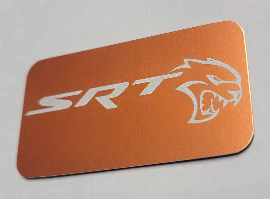 Laser‑engraved orange anodized Hellcat supercharger lid badge